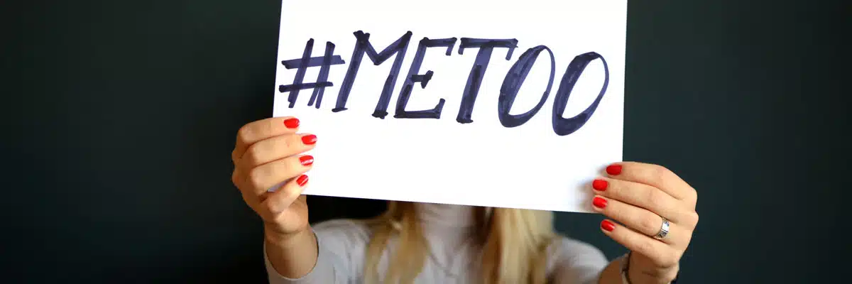 Woman Holding up Paper that Reads #Metoo