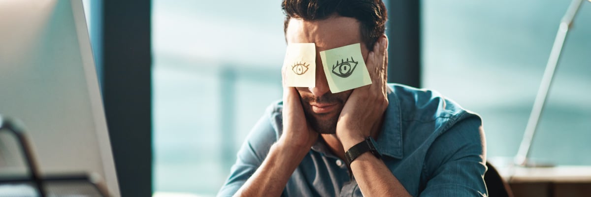 Man with Sticky Notes Placed over Eyes with Open Eyed Drawn on