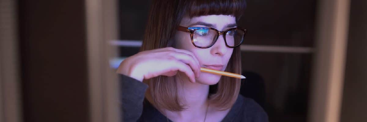 Woman Concentrating while Holding A Pencil
