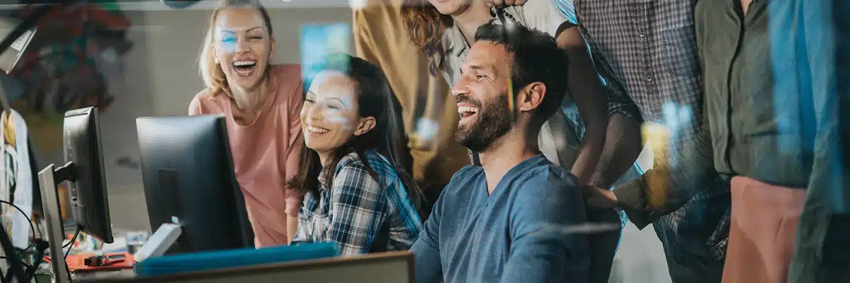 People Laughing at a Computer Screen