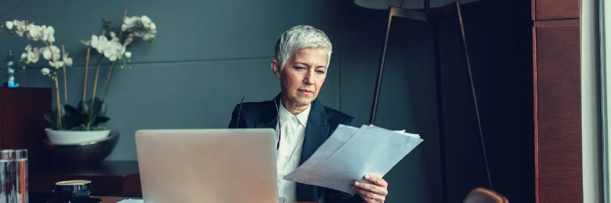 Woman in Office Looking at Papers