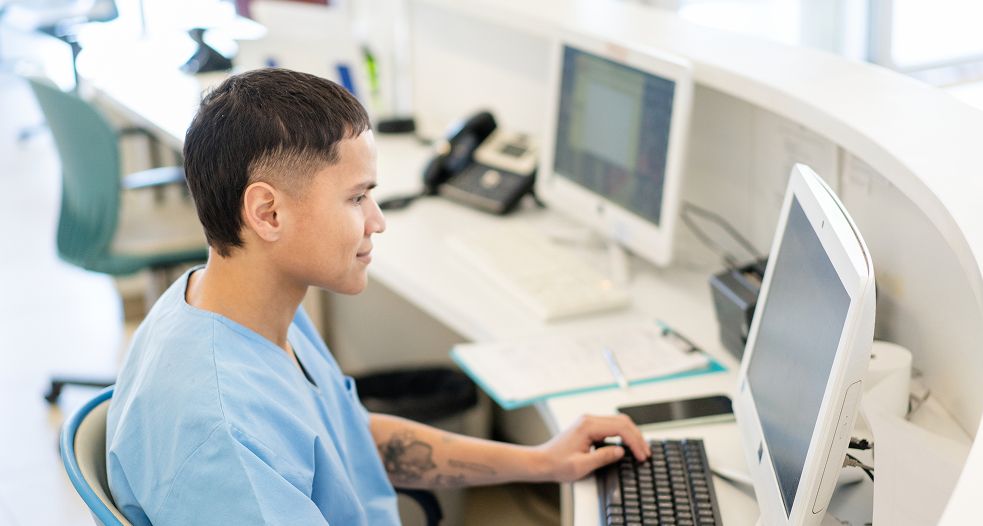 Image shows a professional man working on his laptop.