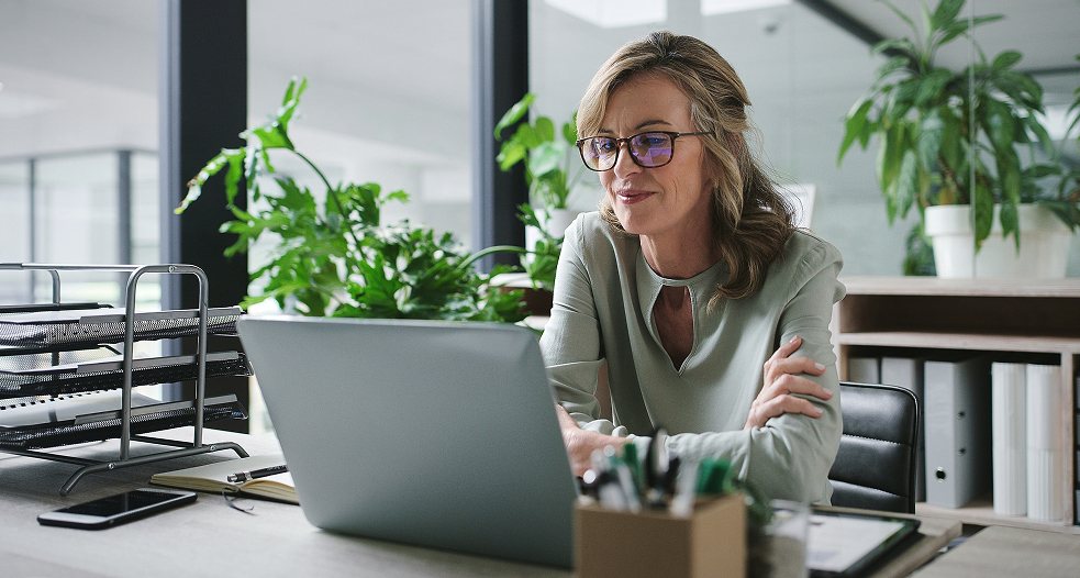 A woman focused on here laptop